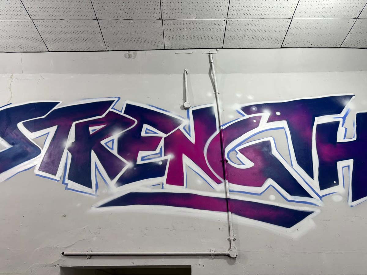 Strength graffiti mural in the gym