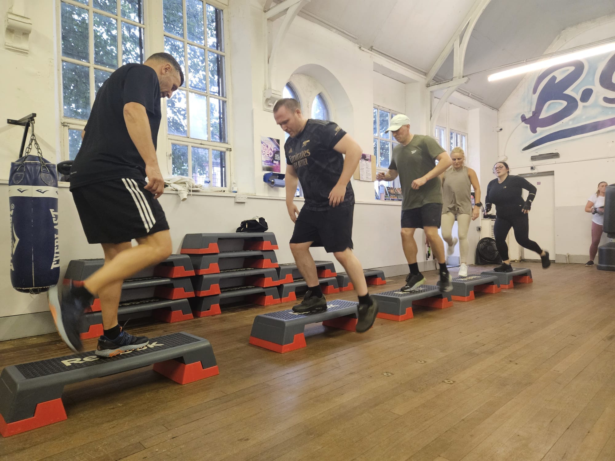Members coached through a small-group step-up circuit at B-Strong