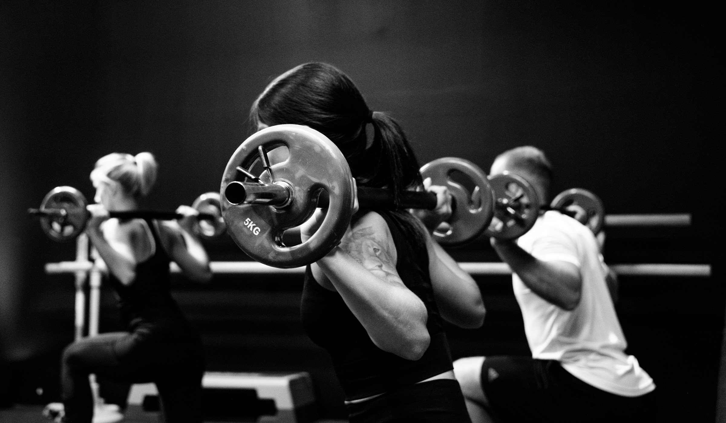 Members training with barbells in the B-Strong studio